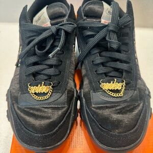 Nike Black Sneakers with Gold Detailing